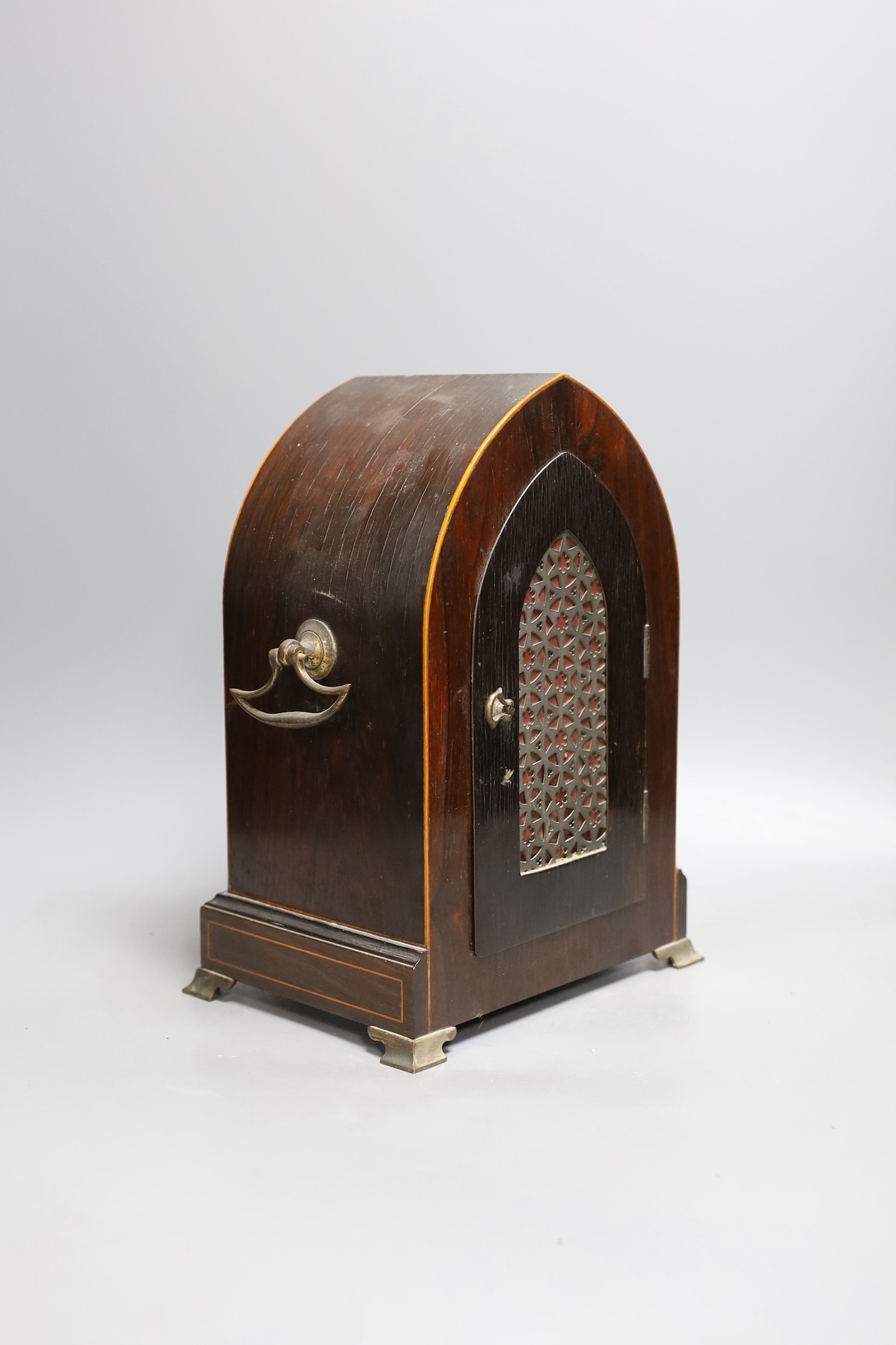 An early 20th century mahogany inlaid dome topped mantel clock, 30 cms high.